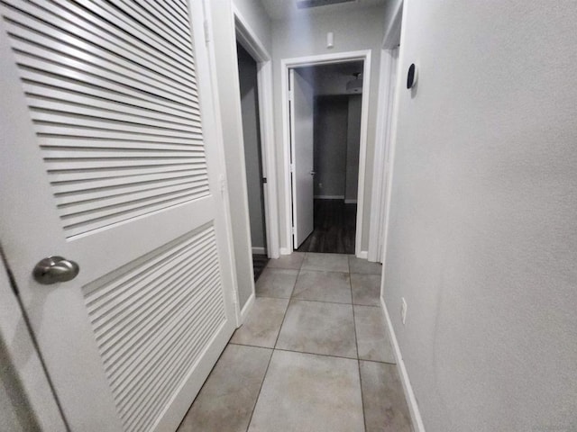 hallway featuring light tile patterned floors