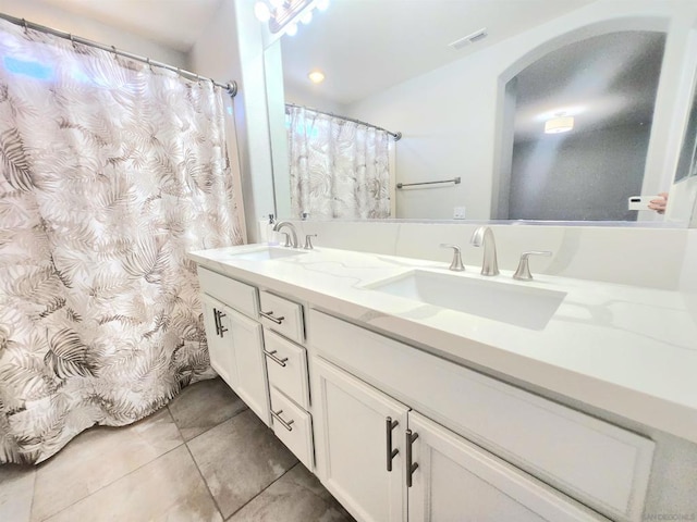 bathroom with tile patterned floors and vanity