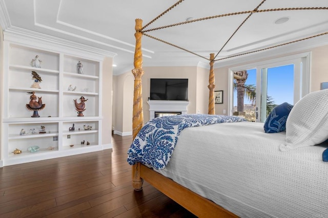 bedroom with baseboards, ornamental molding, dark wood-style flooring, and access to exterior