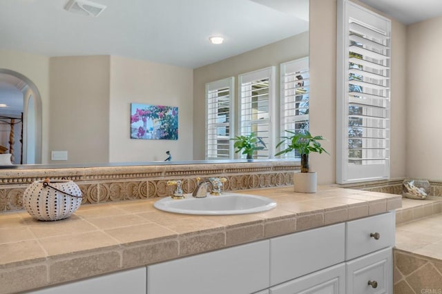 bathroom featuring visible vents, vanity, and a wealth of natural light