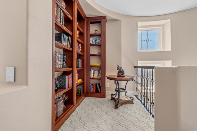 sitting room featuring baseboards and carpet flooring