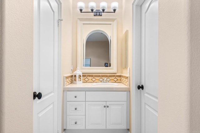 bathroom with vanity and decorative backsplash