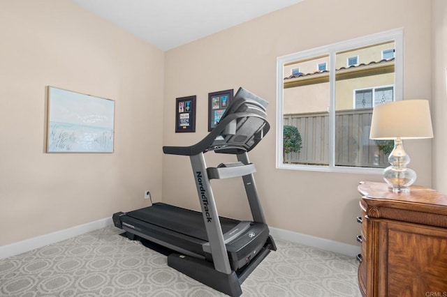 workout room featuring baseboards