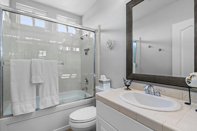 bathroom featuring shower / bath combination with glass door, vanity, and toilet