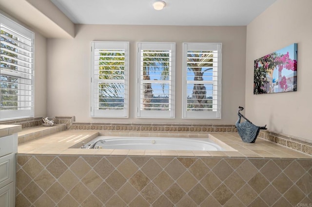 bathroom with a healthy amount of sunlight and a bath