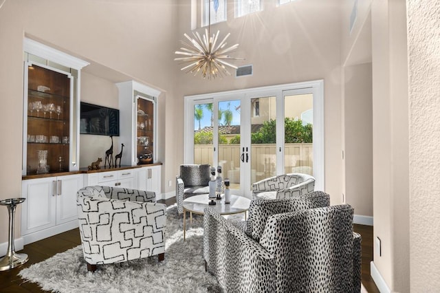living room with dark wood-style flooring, a chandelier, french doors, baseboards, and visible vents