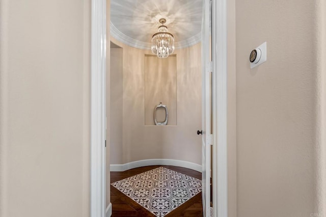 bathroom with baseboards, wood finished floors, and a chandelier