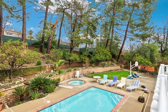 view of swimming pool with a patio and an in ground hot tub