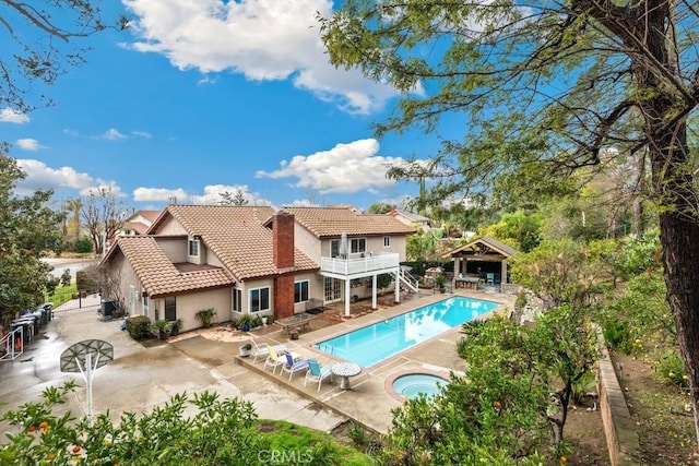 view of swimming pool with an in ground hot tub and a patio