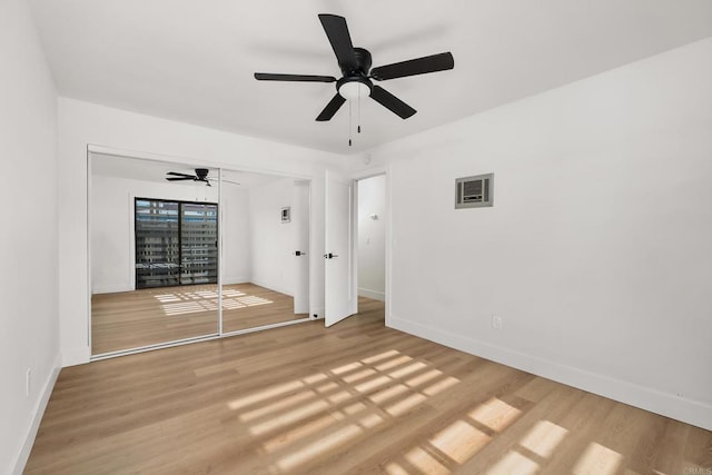 unfurnished bedroom with a closet, ceiling fan, and light wood-type flooring