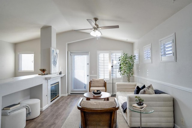 living room featuring vaulted ceiling, ceiling fan, and light hardwood / wood-style floors