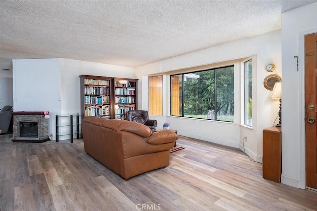 living room with light hardwood / wood-style floors and a textured ceiling