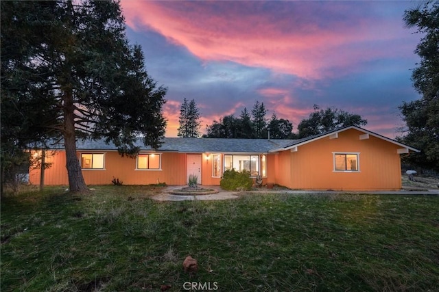 ranch-style house featuring a yard