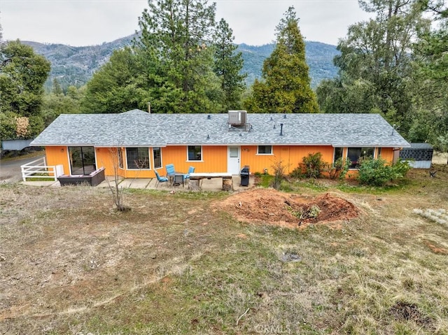 rear view of house featuring a patio, a mountain view, and central AC unit