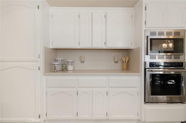 kitchen featuring appliances with stainless steel finishes and white cabinets