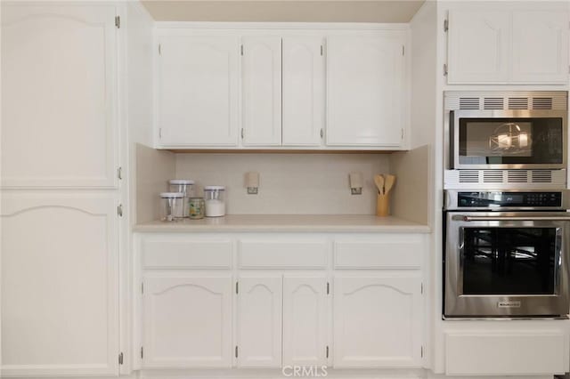 5045 Malibu Dr, Paradise, CA 95969 - kitchen featuring stainless steel appliances, white cabinets, and light countertops