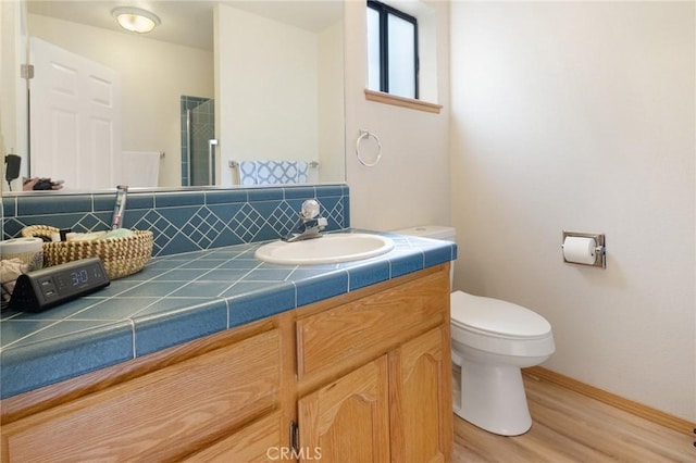 5045 Malibu Dr, Paradise, CA 95969 - full bathroom with decorative backsplash, vanity, wood finished floors, and a shower