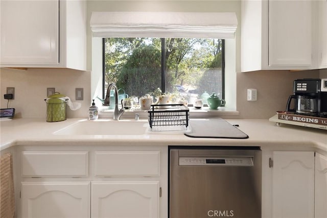 5045 Malibu Dr, Paradise, CA 95969 - kitchen with stainless steel dishwasher, white cabinets, decorative backsplash, and light countertops
