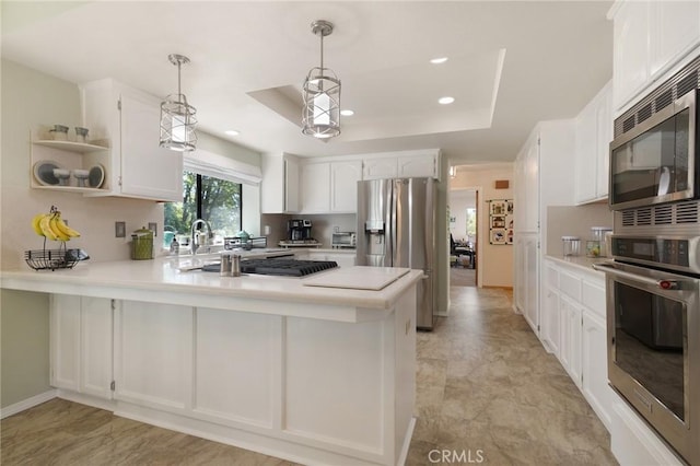 5045 Malibu Dr, Paradise, CA 95969 - kitchen featuring appliances with stainless steel finishes, a peninsula, light countertops, white cabinetry, and recessed lighting