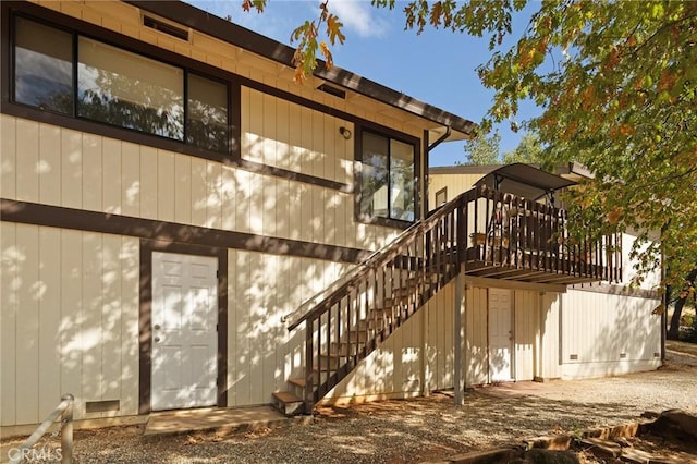 back of house featuring a wooden deck