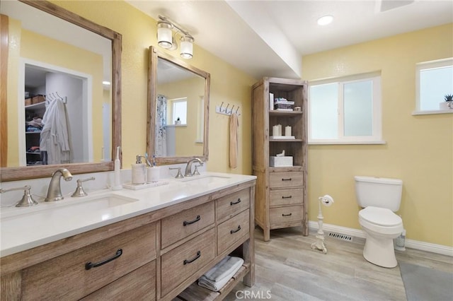 5045 Malibu Dr, Paradise, CA 95969 - full bathroom featuring double vanity, wood finished floors, and plenty of natural light