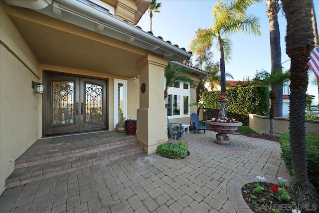 entrance to property featuring a patio and french doors