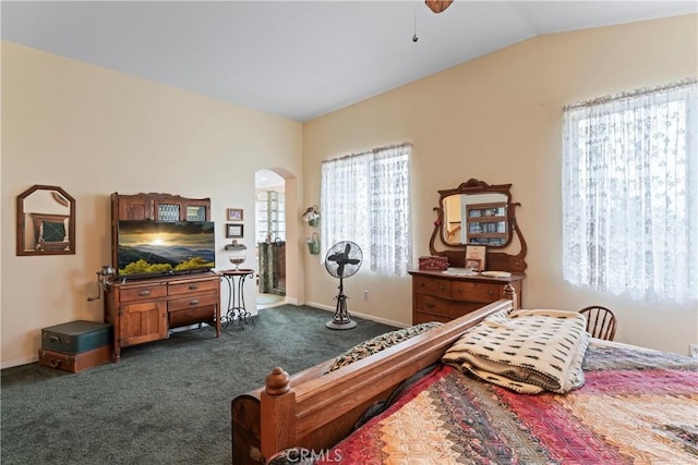 bedroom with ceiling fan, lofted ceiling, and dark carpet