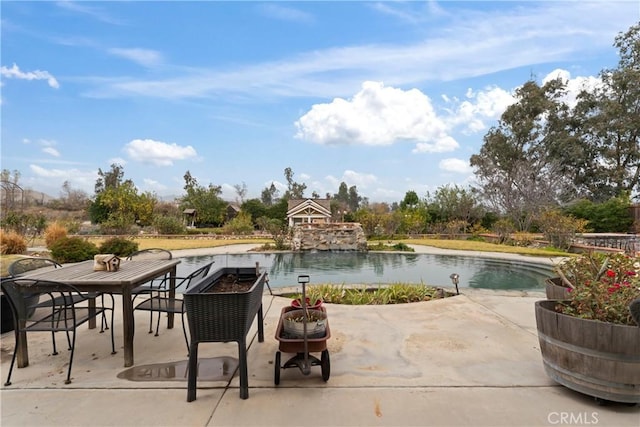 view of pool with a water view and a patio area