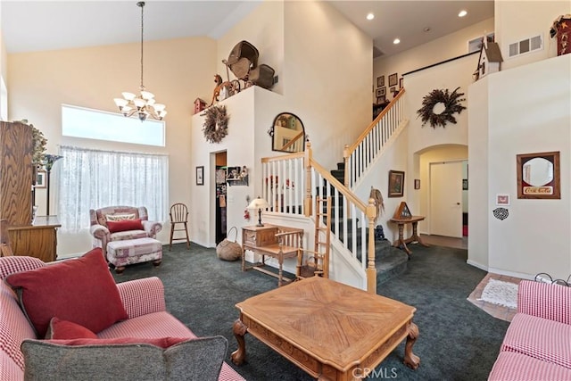 living room with dark colored carpet, a notable chandelier, and high vaulted ceiling