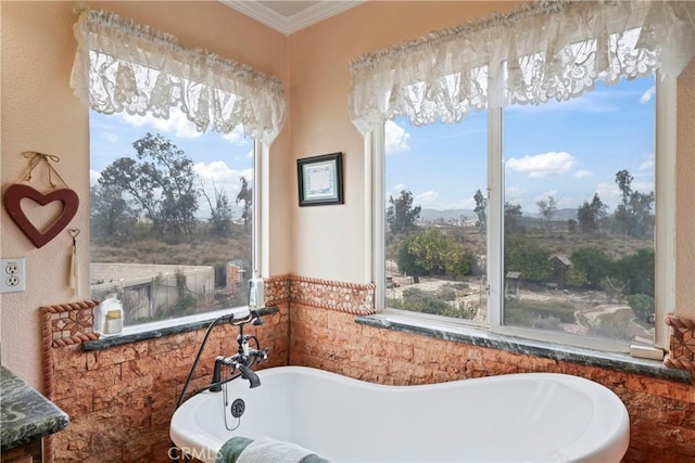 bathroom with a bath, plenty of natural light, and ornamental molding