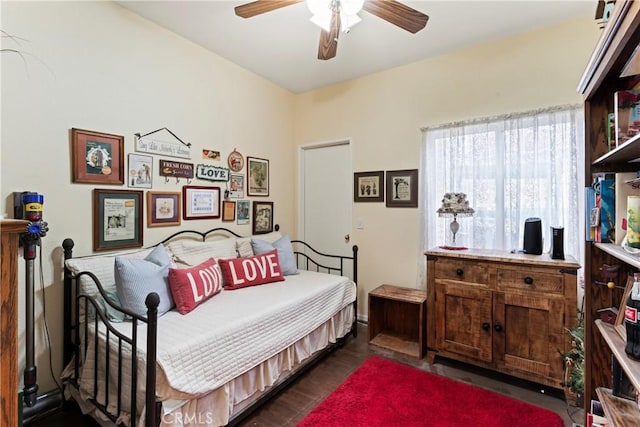 bedroom with dark hardwood / wood-style flooring and ceiling fan