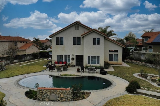 back of house featuring a fenced in pool, outdoor lounge area, a yard, and a patio area