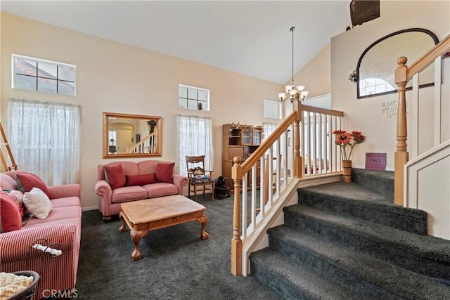 carpeted living room featuring high vaulted ceiling, a chandelier, and a healthy amount of sunlight