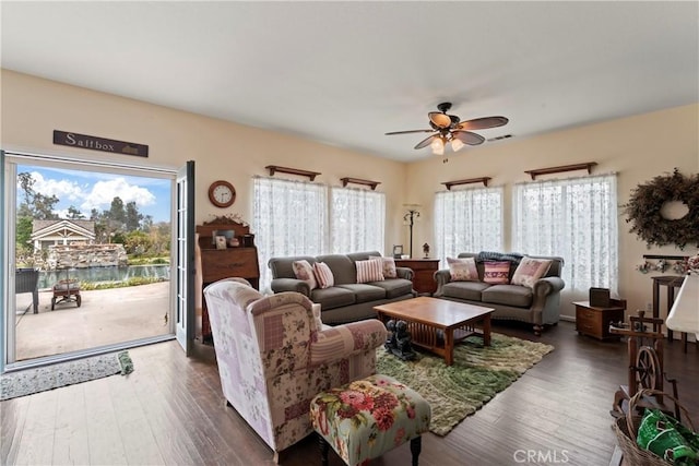 living room featuring dark hardwood / wood-style floors and ceiling fan