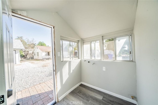 unfurnished sunroom featuring vaulted ceiling