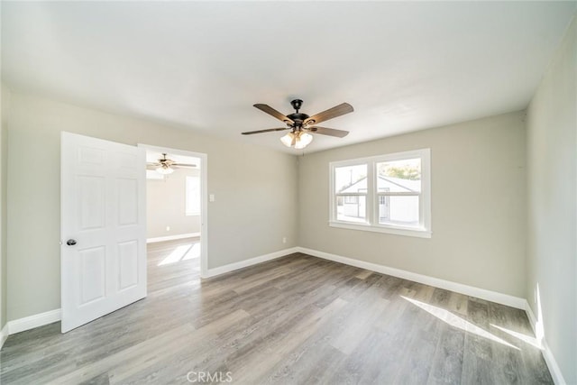 empty room featuring ceiling fan and light wood-type flooring