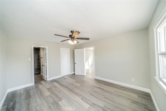 unfurnished bedroom with ceiling fan and light hardwood / wood-style flooring