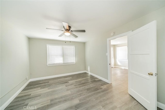 unfurnished room featuring hardwood / wood-style flooring and ceiling fan