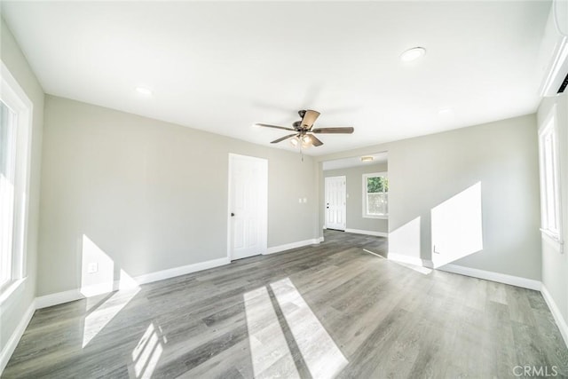 empty room with ceiling fan and wood-type flooring