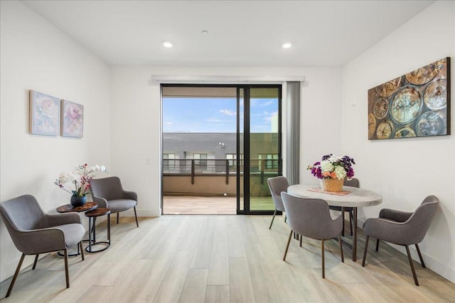 dining space with light hardwood / wood-style flooring