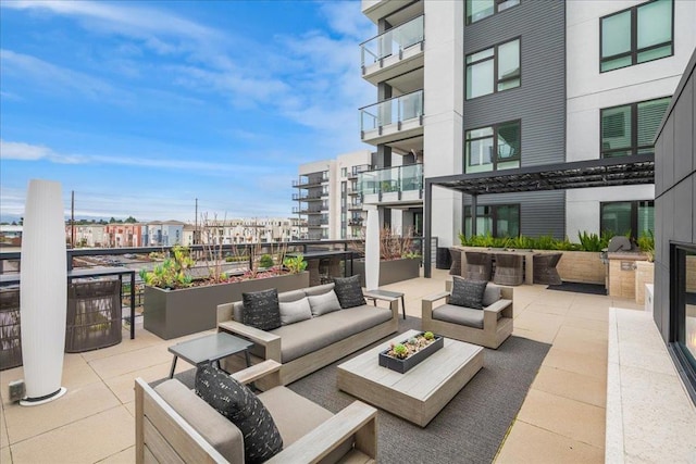 view of patio / terrace with a balcony and outdoor lounge area