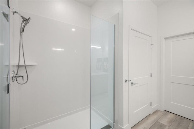 bathroom with wood-type flooring and a shower