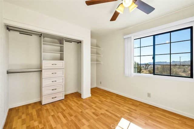 unfurnished bedroom featuring a closet, ceiling fan, and light hardwood / wood-style flooring