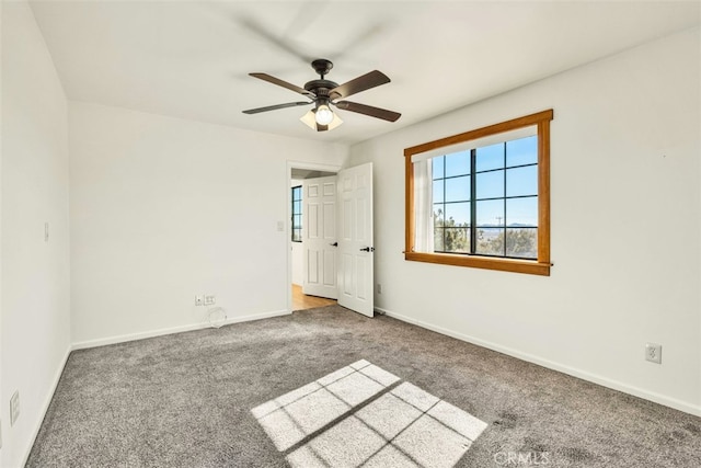 interior space featuring light colored carpet and ceiling fan