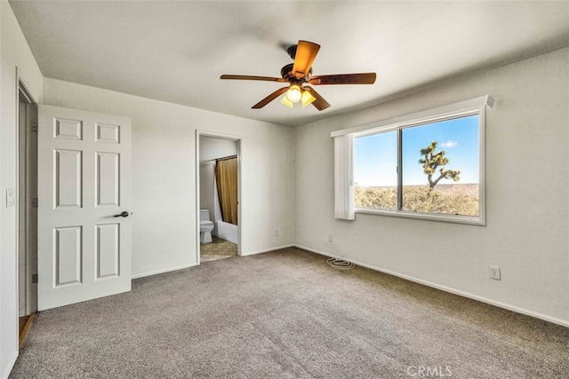 unfurnished bedroom featuring ensuite bathroom, carpet, and ceiling fan