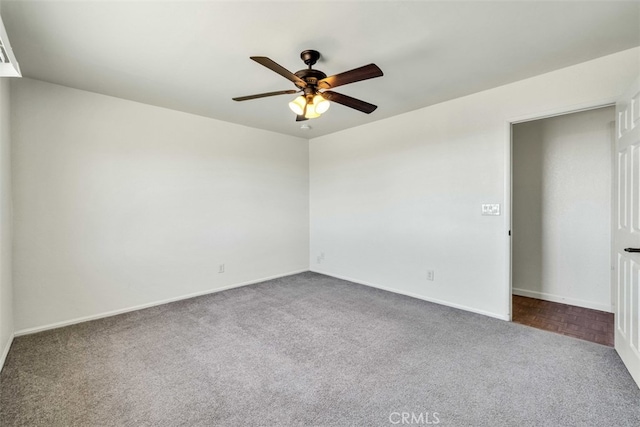 carpeted spare room featuring ceiling fan