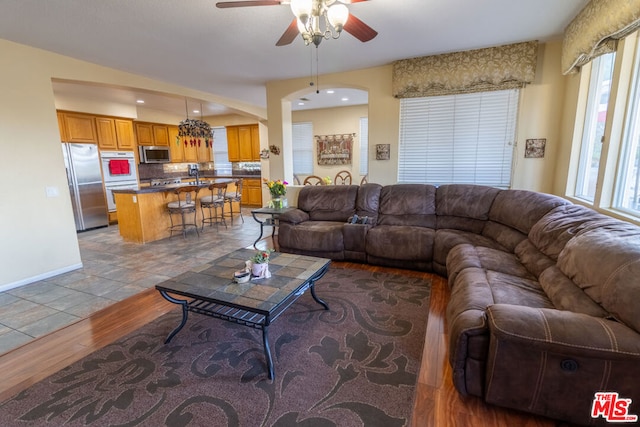 living room with ceiling fan, plenty of natural light, and light hardwood / wood-style floors