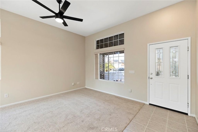 carpeted foyer entrance with ceiling fan