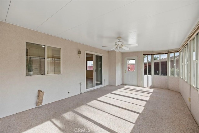 unfurnished sunroom with ceiling fan