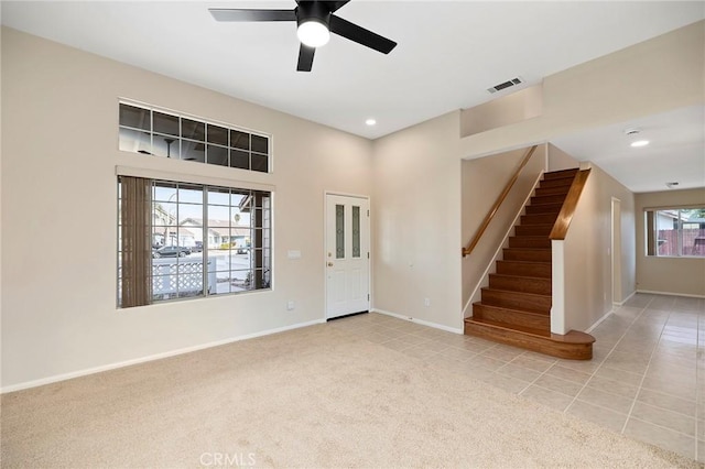 entryway with light colored carpet and ceiling fan